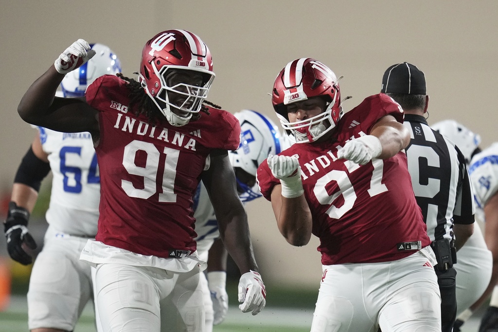 Indiana 's Mario Landino (97) celebrates a sack with Dominique Ratcliff (91) during the second half of an NCAA college football game against Indiana State, Friday, Sept. 12, 2025, in Bloomington, Ind. (AP Photo/Darron Cummings)