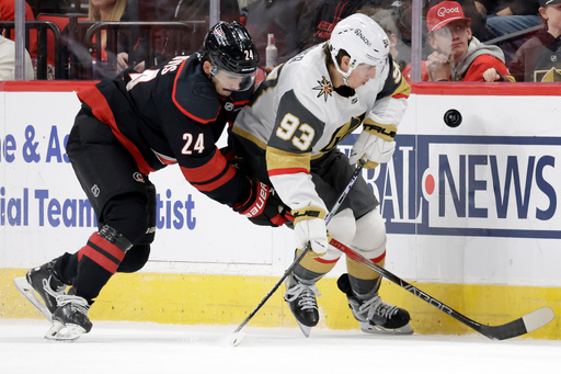 Carolina Hurricanes center Seth Jarvis (24) and Vegas Golden Knights right wing Mitch Marner (93) go for the puck during the first period of an NHL hockey game Tuesday, Oct. 28, 2025, in Raleigh, N.C. (AP Photo/Chris Seward) Carolina Hurricanes center Seth Jarvis (24) and Vegas Golden Knights right wing Mitch Marner (93) go for the puck during the first period of an NHL hockey game Tuesday, Oct. 28, 2025, in Raleigh, N.C. (AP Photo/Chris Seward)