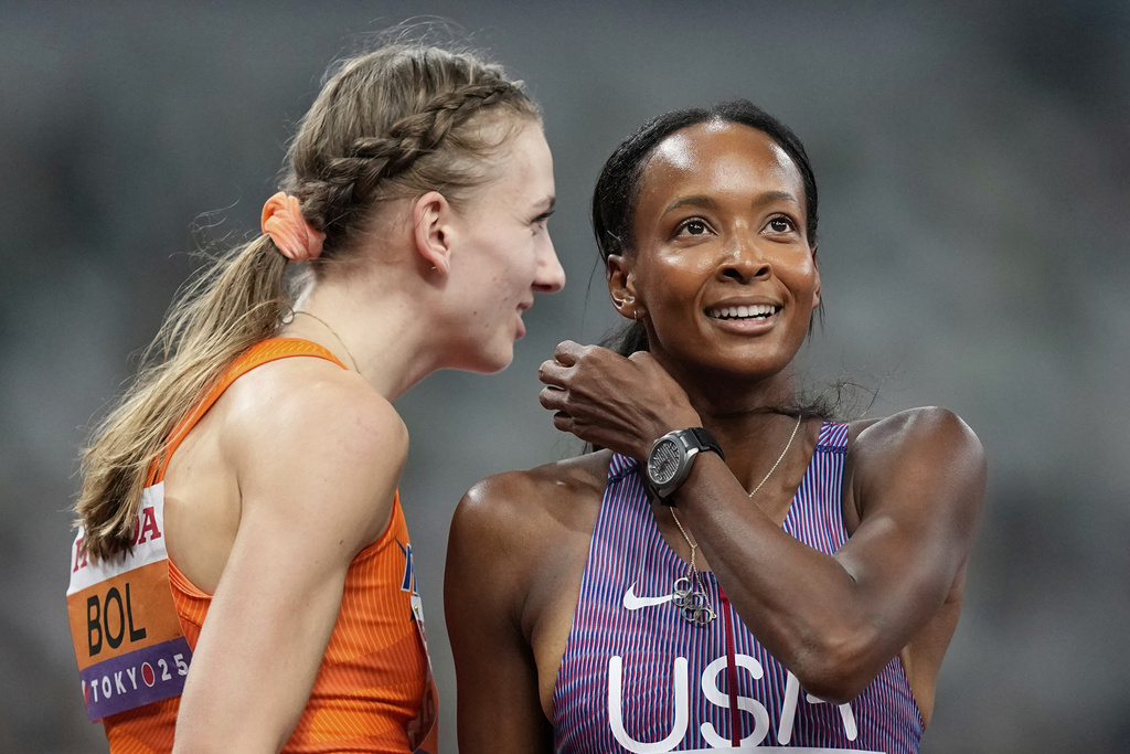 Netherlands' Femke Bol chats to United States' Dalilah Muhammad after they finished a women's 400 meters hurdles semifinal at the World Athletics Championships in Tokyo, Wednesday, Sept. 17, 2025. (AP Photo/Petr David Josek)
