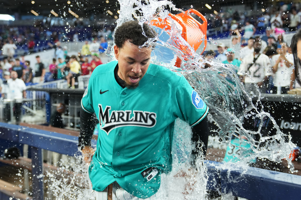 Miami Marlins' Heriberto Hernández is doused after hitting a walk-off grand slam during the ninth inning to defeat the New York Mets in a baseball game, Sunday, May 24, 2026, in Miami. (AP Photo/Lynne Sladky)