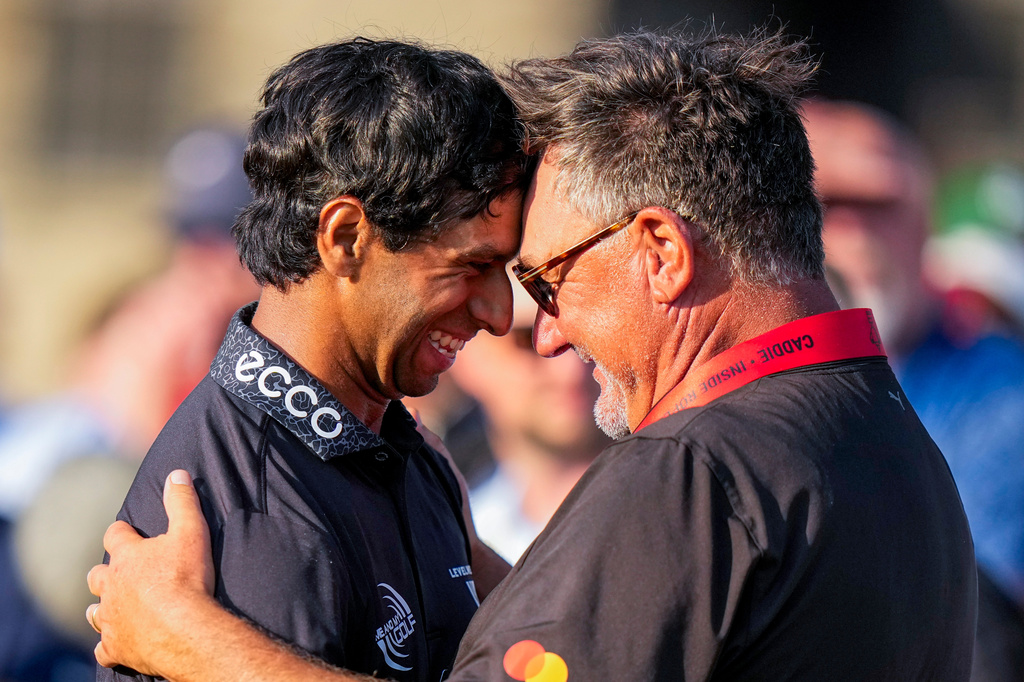 Aaron Rai, of England, left, hugs Justin Rose's caddie Mark Fulcher after finishing on the 18th green during the final round of the PGA Championship golf tournament at Aronimink Golf Club, Sunday, May 17, 2026, in Newtown Square, PA. (AP Photo/Frank Franklin II)