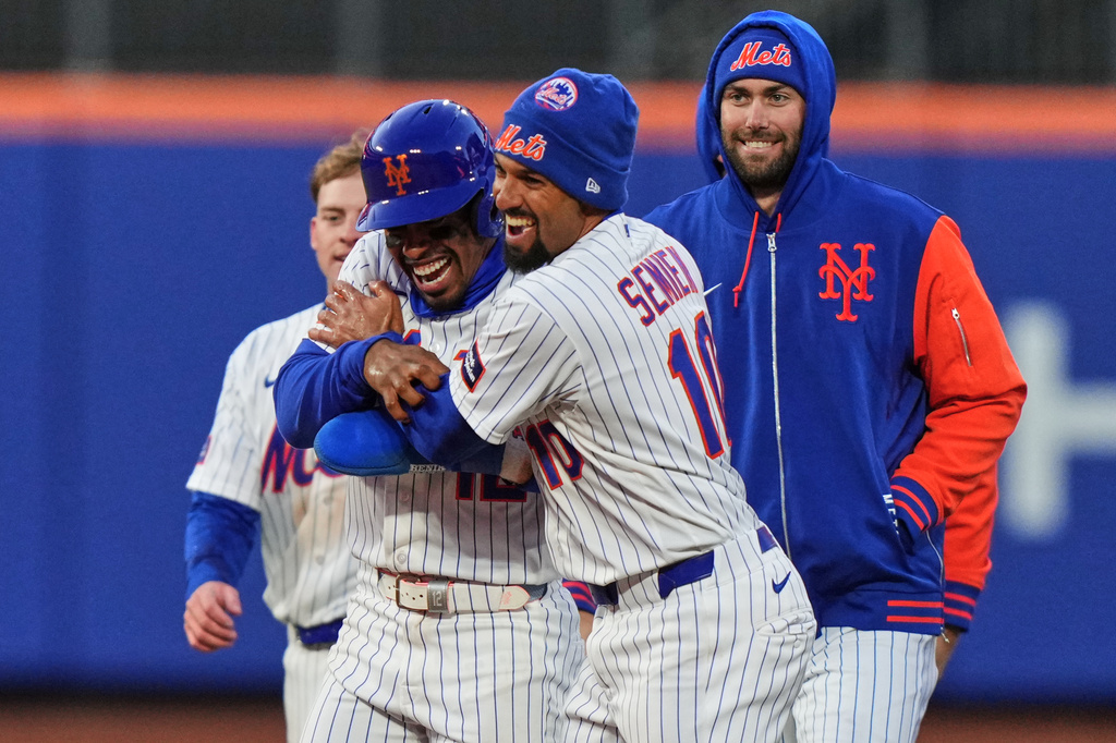 New York Mets' Francisco Lindor (12) celebrates with teammate Marcus Semien (10) after a baseball game against the Arizona Diamondbacks Tuesday, April 7, 2026, in New York. (AP Photo/Frank Franklin II)