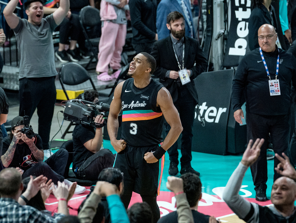 San Antonio Spurs forward Keldon Johnson (3) celebrates a three point basket against the Oklahoma Thunder during the second half of an NBA basketball game in San Antonio, Tuesday, Dec. 23, 2025. (AP Photo/Rodolfo Gonzalez)