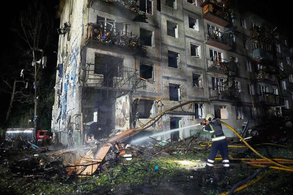 Emergency services personnel work to extinguish a fire following Russian missile attacks in Kyiv, Ukraine, Saturday, Aug. 1, 2026. (AP Photo/Efrem Lukatsky)