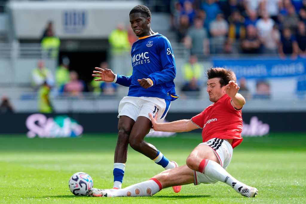 Everton's Thierno Barry, left, is tackled by Manchester United's Harry Maguire during the English Premier League soccer match between Everton and Manchester United in Liverpool, England, Sunday Sept. 6, 2026. (Peter Byrne/PA via AP)