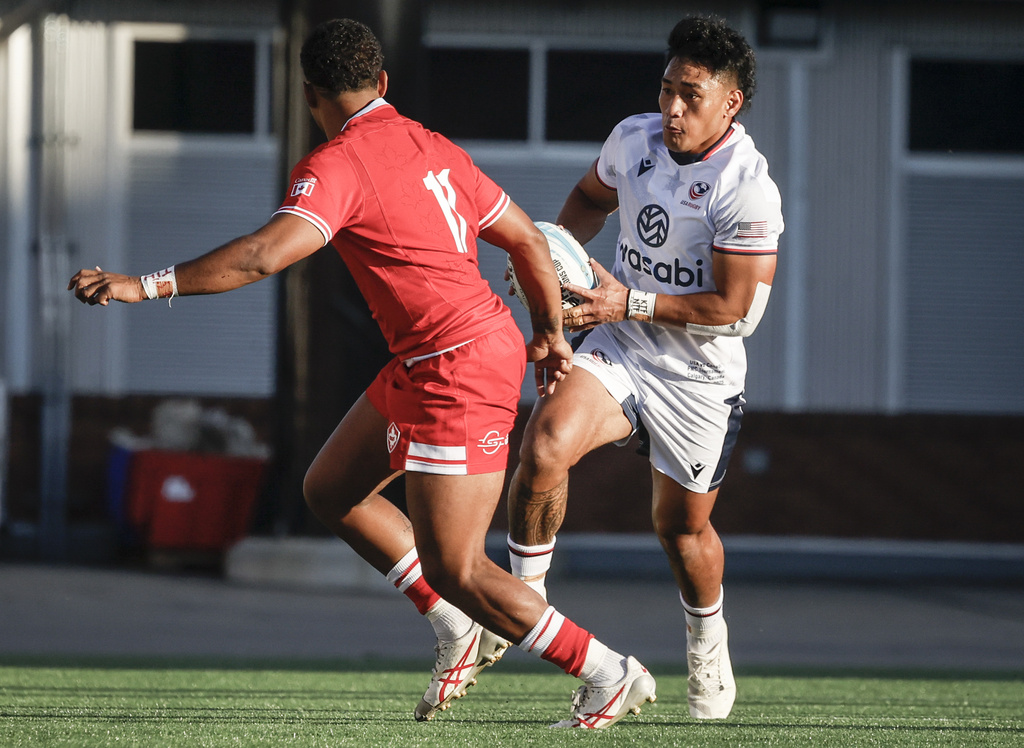 United States' Lauina Futi, right, looks to get past Canada's Josiah Morra, left, during first-half Pacific Nations Cup rugby match action in Calgary, Alberta, Friday, Aug. 22, 2025. (Jeff McIntosh/The Canadian Press via AP)