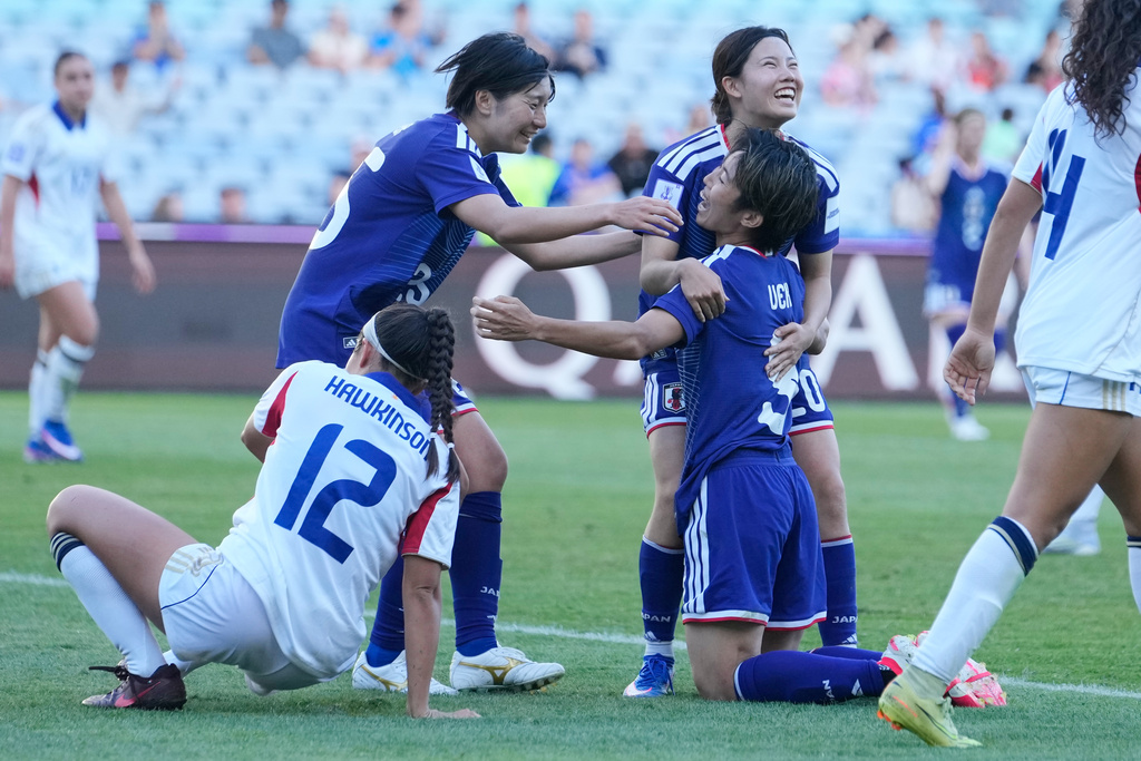 Japan's Riko Ueki, right,, is congratulated by teammates after scoring her team's seventh goal during the Women's Asian Cup quarterfinal soccer match between Japan and the Philippines in Sydney, Sunday, March 15, 2026. (AP Photo/Rick Rycroft)