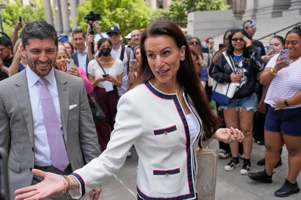 Karen Friedman Agnifilo, center, and Jacob Kaplan, left, lawyers for Luigi Mangione, are surrounded by media as they leave a federal courthouse in New York, Monday, June 29, 2026. (AP Photo/Seth Wenig)