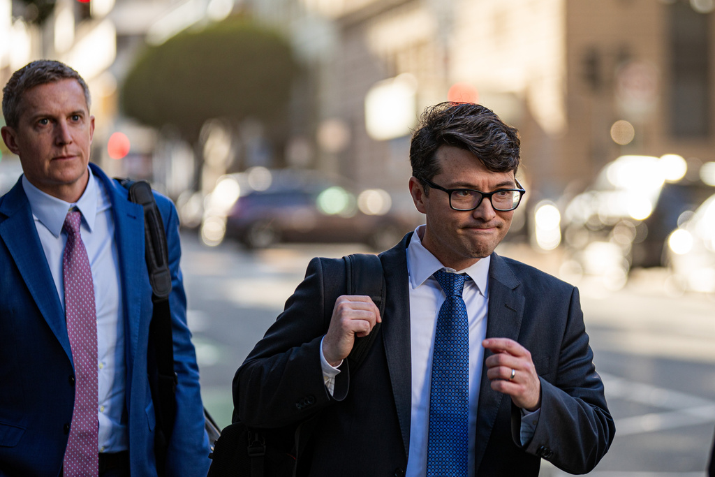 Members of Elon Musk's legal team, including attorney Stephen Broome, left, exit the Phillip Burton Federal Building after representing Elon Musk, in San Francisco, Wednesday, March 4, 2026. (Dan Hernandez/San Francisco Chronicle via AP)