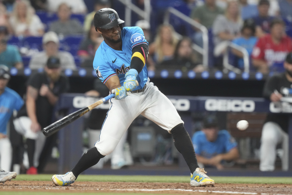 Miami Marlins' Otto Lopez (6) hits a single toi center field during the third inning of a baseball game against the Detroit Tigers Sunday, Sept. 14, 2025, in Miami. (AP Photo/Marta Lavandier)