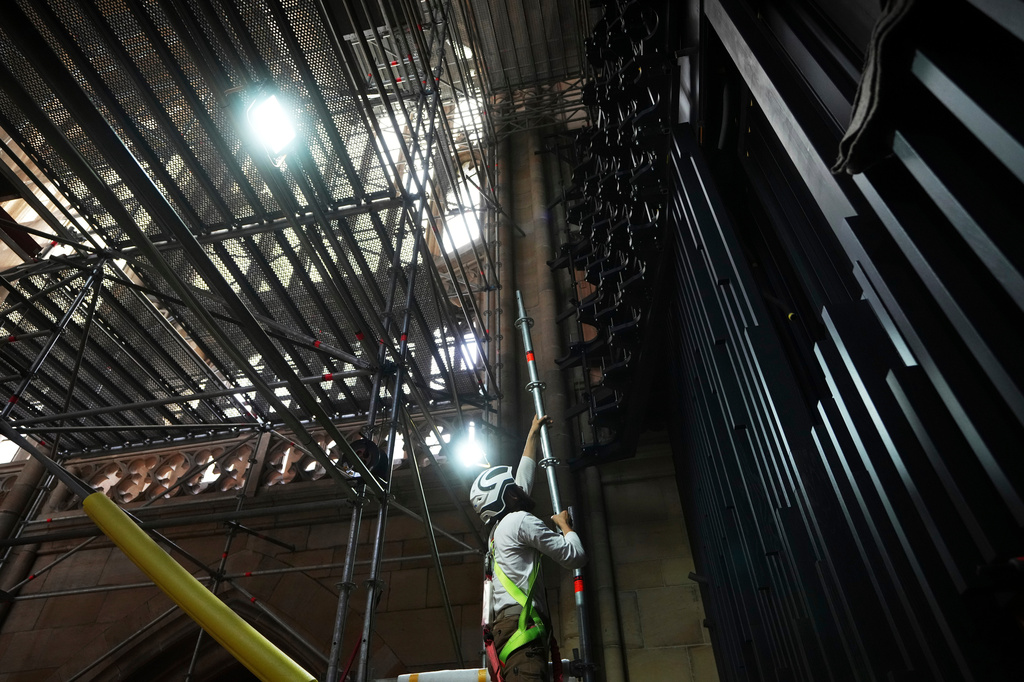 FILE - A worker adjusts scaffolding during the installation of a new organ at Prague's St. Vitus Cathedral that is coming to its final stages in Prague, Czech Republic, Tuesday, July 22, 2025. (AP Photo/Petr David Josek, File)