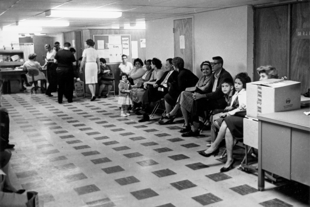 FILE - Cuban exiles wait for processing at the Cuban refugee center in Miami on April 12, 1963. (AP Photo, File)