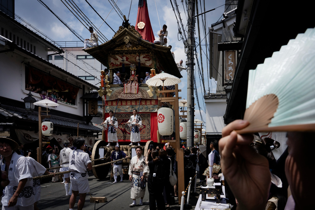 A festival float passes through a narrow street during one of the main parades of Shinto's Gion Matsuri festival in Kyoto, western Japan, Friday, July 17, 2026. (AP Photo/Fred Mery)