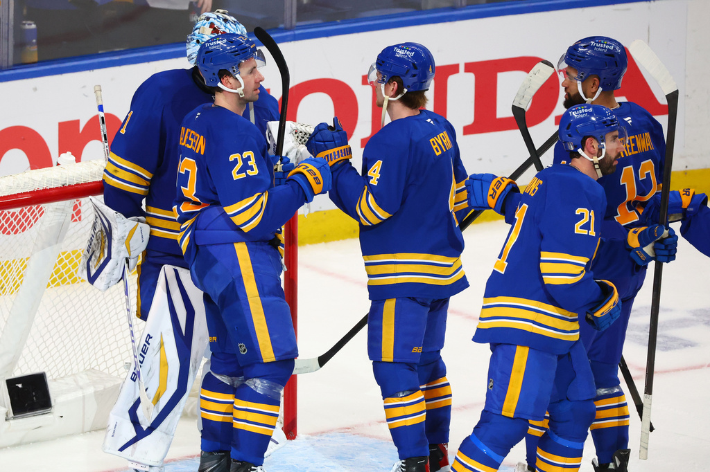 Buffalo Sabres players celebrate victory following the third period in Game 1 of a first-round NHL hockey Stanley Cup playoff series against the Boston Bruins, Sunday, April 19, 2026, in Buffalo, N.Y. (AP Photo/Jeffrey T. Barnes)