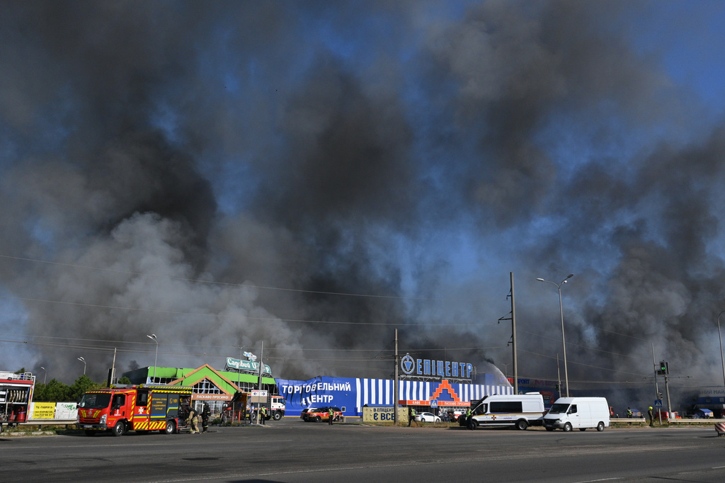 Smoke raises above a shopping mall following a Russian air attack in Odesa, Ukraine, Monday, Aug. 24, 2026. (AP Photo/Michael Shtekel)