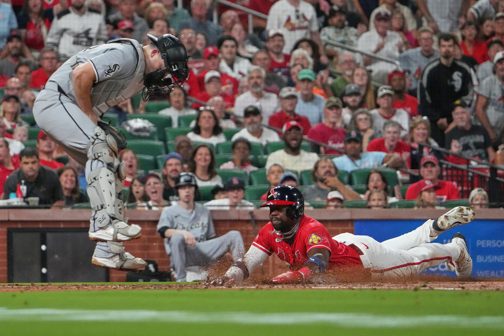 St. Louis Cardinals' Jordan Walker, right, scores past Chicago White Sox catcher Jake Rogers during the third inning of a baseball game Friday, Sept. 11, 2026, in St. Louis. (AP Photo/Jeff Roberson)