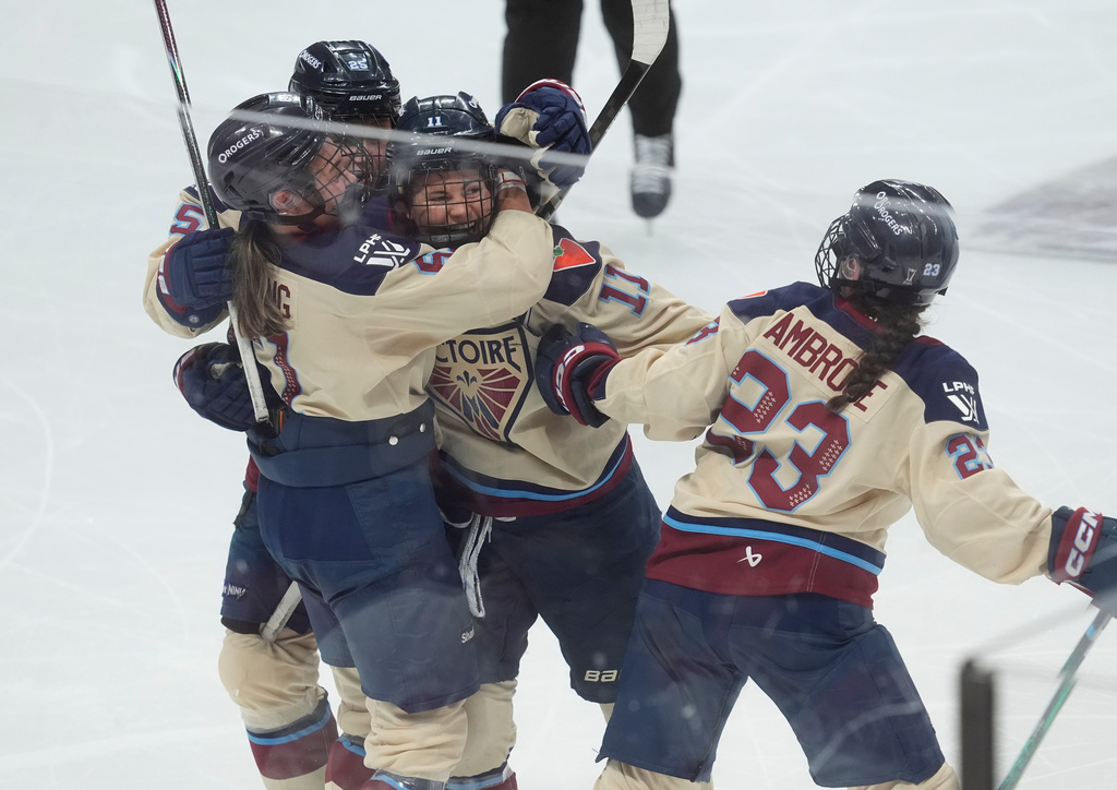 Montreal Victoire forward Abby Roque (11) celebrates her goal against the Ottawa Charge with teammates during the third period of game 4 PWHL Walter Cup final hockey game in Ottawa, Wednesday, May 20, 2026. (Adrian Wyld/The Canadian Press via AP)