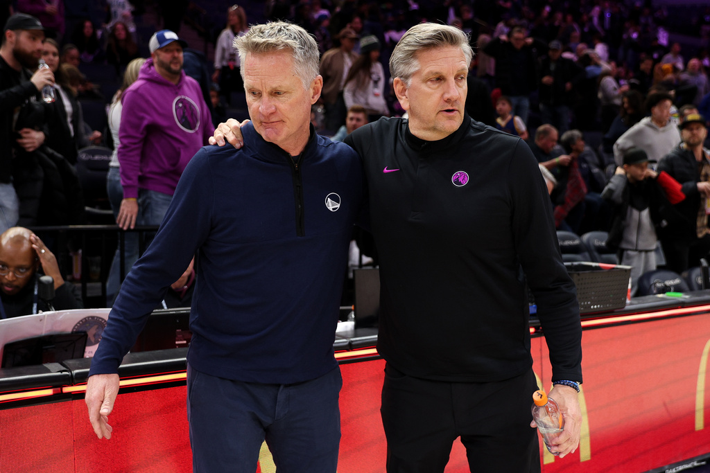 Golden State Warriors head coach Steve Kerr, left, and Minnesota Timberwolves head coach Chris Finch, right, talk after an NBA basketball game Sunday, Jan. 25, 2026, in Minneapolis. (AP Photo/Matt Krohn)