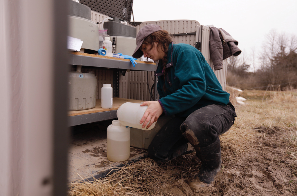 University of Vermont graduate student Delaney Bullock gathers runoff samples from two agricultural fields to be analyzed for nutrient concentrations on Thursday, March 12, 2026, in Bridport, Vt. (AP Photo/Amanda Swinhart)
