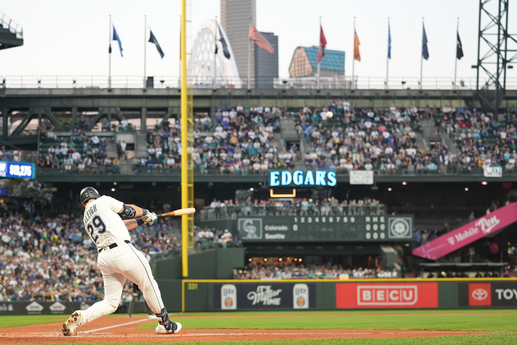 Seattle Mariners' Cal Raleigh hits a solo home run during the first inning of a baseball game against the Colorado Rockies, Wednesday, Sept. 24, 2025, in Seattle. (AP Photo/Ryan Sun)