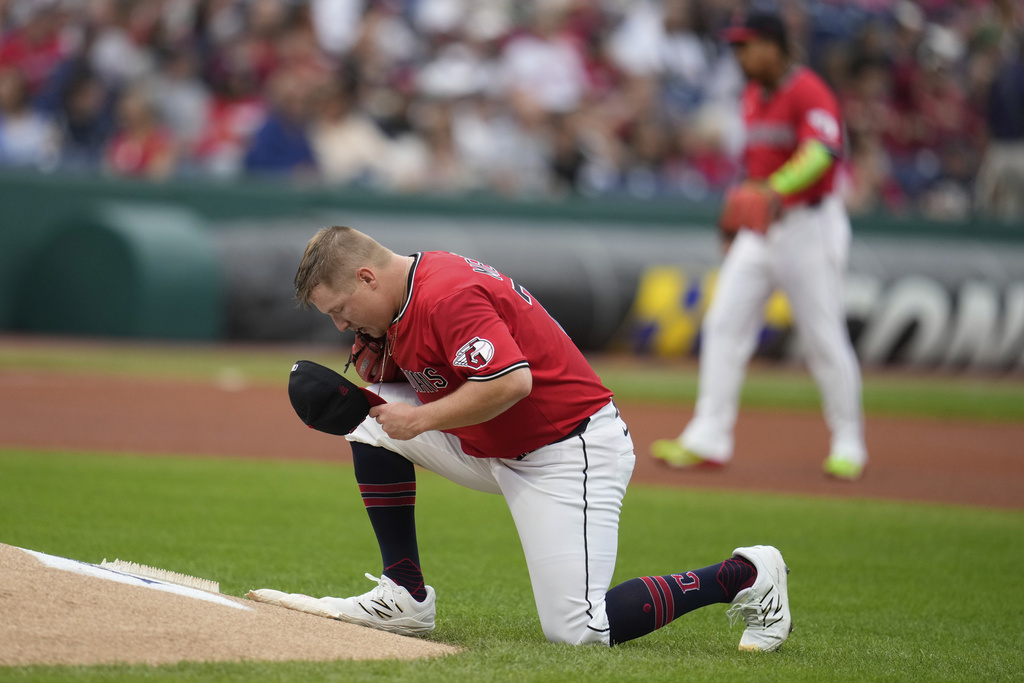 Cleveland Guardians starting pitcher Parker Messick kneels behind the mound in the first inning of baseball game against the Chicago White Sox in Cleveland, Saturday, Sept. 13, 2025. (AP Photo/Sue Ogrocki)