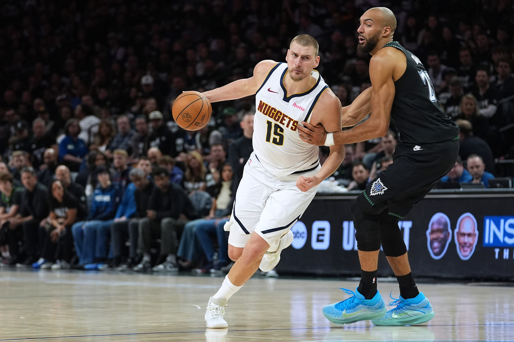 Denver Nuggets center Nikola Jokic (15) works toward the basket as Minnesota Timberwolves center Rudy Gobert, right, defends during the first half of Game 4 of a first-round NBA basketball playoff series, Saturday, April 25, 2026, in Minneapolis. (AP Photo/Abbie Parr)