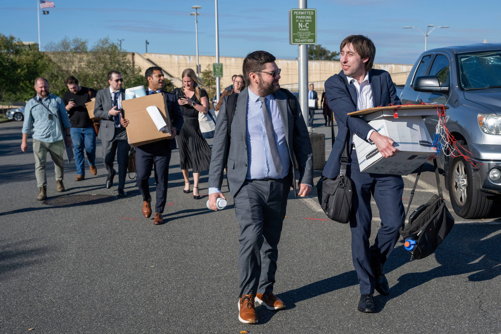 Members of the Pentagon press corp carry their belongings out of the Pentagon after turning in their press credentials, Wednesday, Oct. 15, 2025 in Washington. (AP Photo/Kevin Wolf)