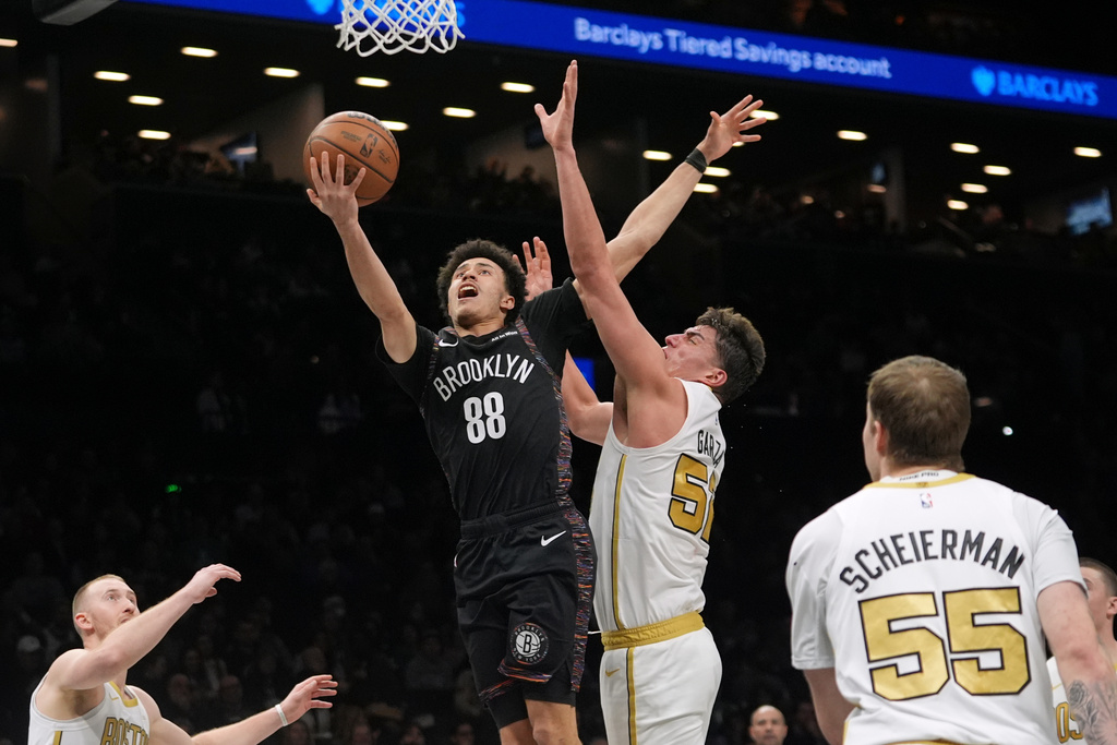 Brooklyn Nets' Nolan Traore (88) drives past Boston Celtics' Luka Garza (52) during the first half of an NBA basketball game Friday, Jan. 23, 2026, in New York. (AP Photo/Frank Franklin II)