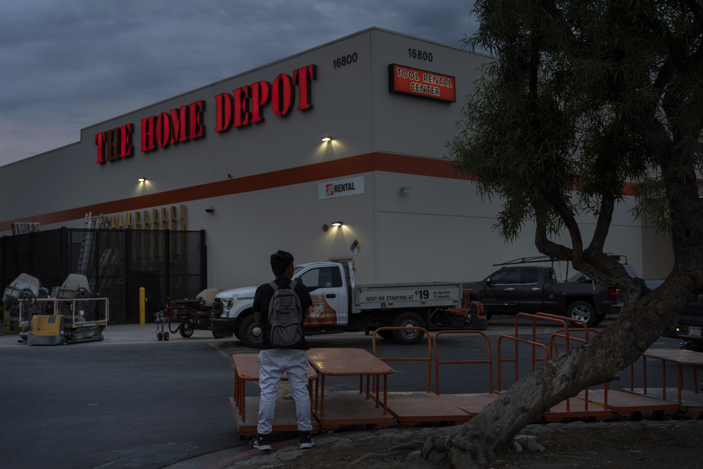 A day laborer waits for work in the parking lot of a Home Depot in the Van Nuys section of Los Angeles, TAug. 28, 2025. (AP Photo/Jae C. Hong)