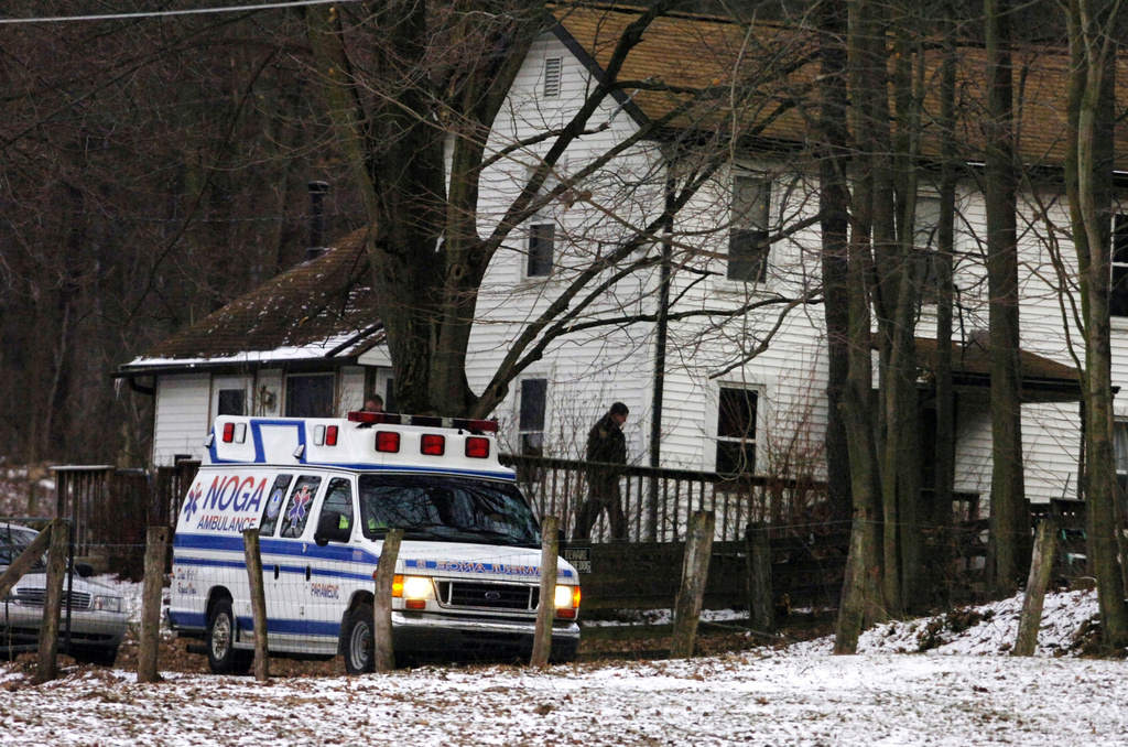 FILE - An ambulance is parked outside the farmhouse where Kenzie Marie Houk was killed in Wampum, Pa., on Feb. 21, 2009. (Kevin Lorenzi/Beaver County Times via AP, File)