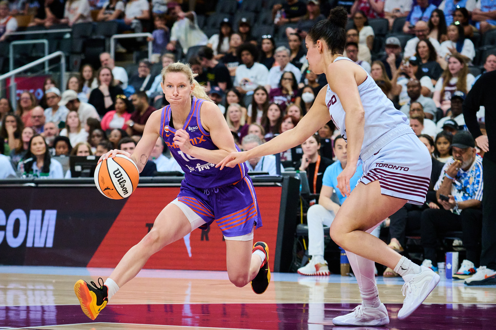 Phoenix Mercury's Lexi Held (10) drives past Toronto Tempo's Kia Nurse (11) during first half of an WNBA basketball game in Toronto, on Saturday, June 27, 2026. (Sammy Kogan /The Canadian Press via AP)