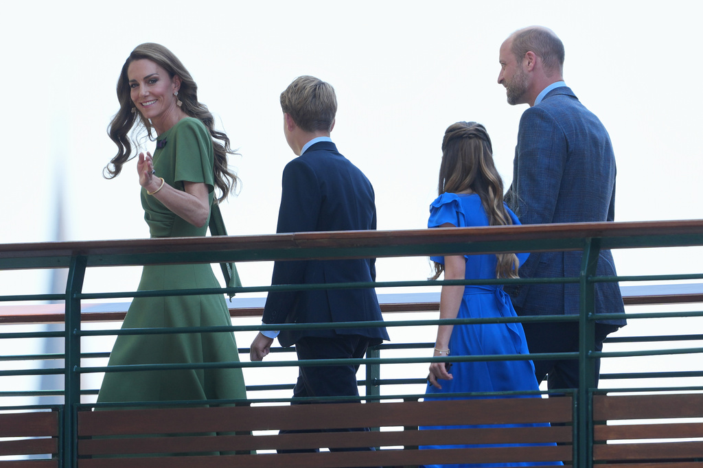 Kate, Princess of Wales wave as she walks with Prince George, Princess Charlotte, Prince William towards Centre Court for the men's singles final at Wimbledon Tennis Championships in London, Sunday, July 12, 2026. (AP Photo/Kin Cheung)