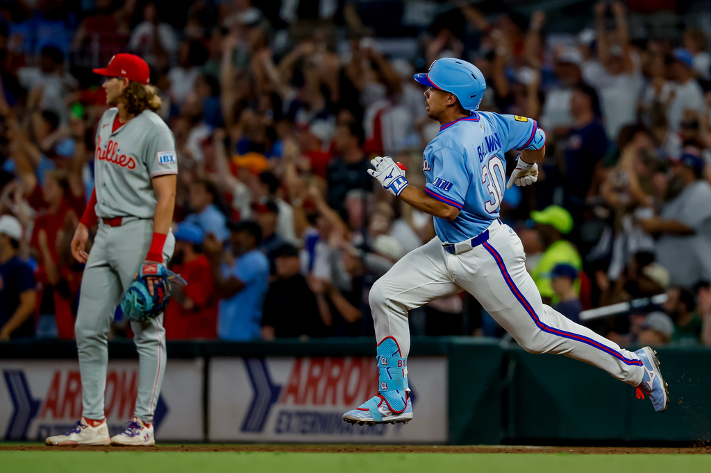 Atlanta Braves designated hitter Drake Baldwin, right, rounds first base after hitting a two-run double against the Philadelphia Phillies during the fourth inning of a baseball game, Saturday, Sept. 12, 2026, in Atlanta. (AP Photo/Erik S. Lesser)
