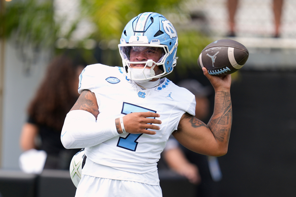 FILE - North Carolina quarterback Gio Lopez warms up before the first half of an NCAA college football game against Central Florida, Sept. 20, 2025, in Orlando, Fla. (AP Photo/John Raoux, File)