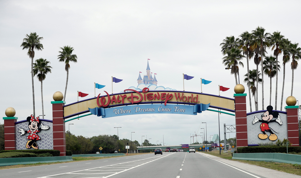 FILE - The road to the entrance of Walt Disney World, Monday, March 16, 2020, in Lake Buena Vista, Fla. (AP Photo/John Raoux, File)
