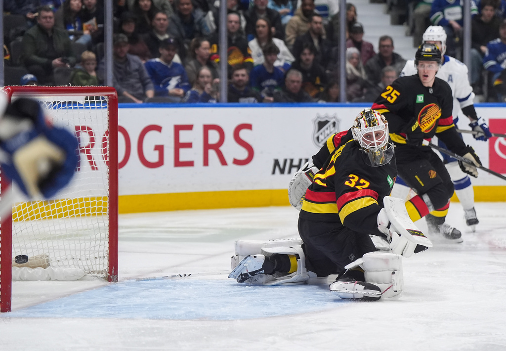 Vancouver Canucks goalie Kevin Lankinen (32) allows a goal to Tampa Bay Lightning's Darren Raddysh, not seen, during the second period of an NHL hockey game, in Vancouver, British Columbia, on Thursday, March 19, 2026. (Darryl Dyck/The Canadian Press via AP)