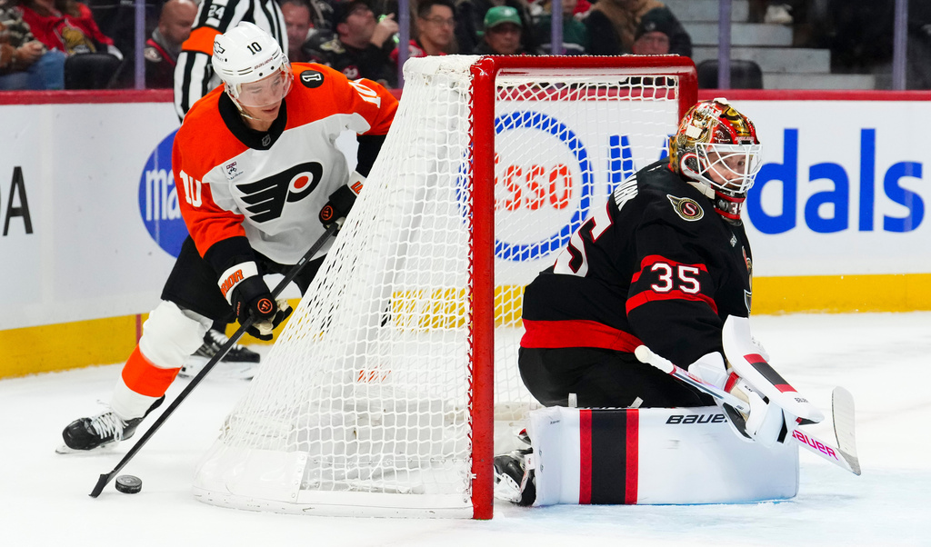 Philadelphia Flyers' Bobby Brink (10) attempts to wrap the puck around the net on Ottawa Senators goaltender Linus Ullmark (35) during first period NHL hockey action in Ottawa on Thursday, Oct. 23, 2025. (Sean Kilpatrick/The Canadian Press via AP)