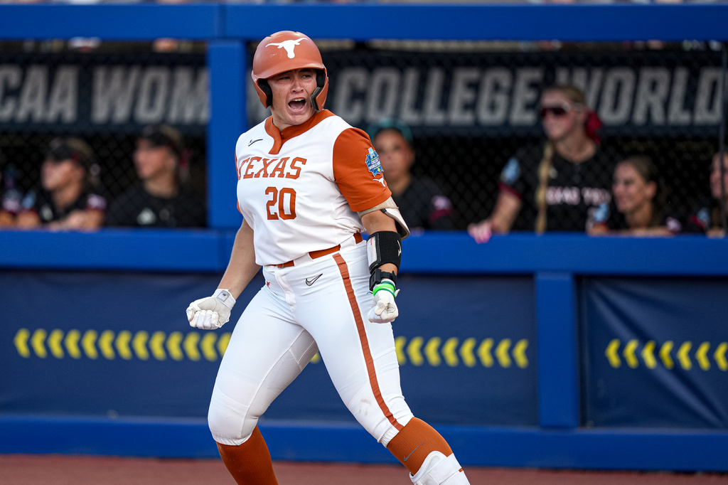 Texas' Katie Stewart (20) celebrates a home run during Game 1 of the NCAA Women's College World Series softball championship series against Texas Tech on Wednesday, June 3, 2026, in Oklahoma City. (Aaron E. Martinez/Austin American-Statesman via AP)