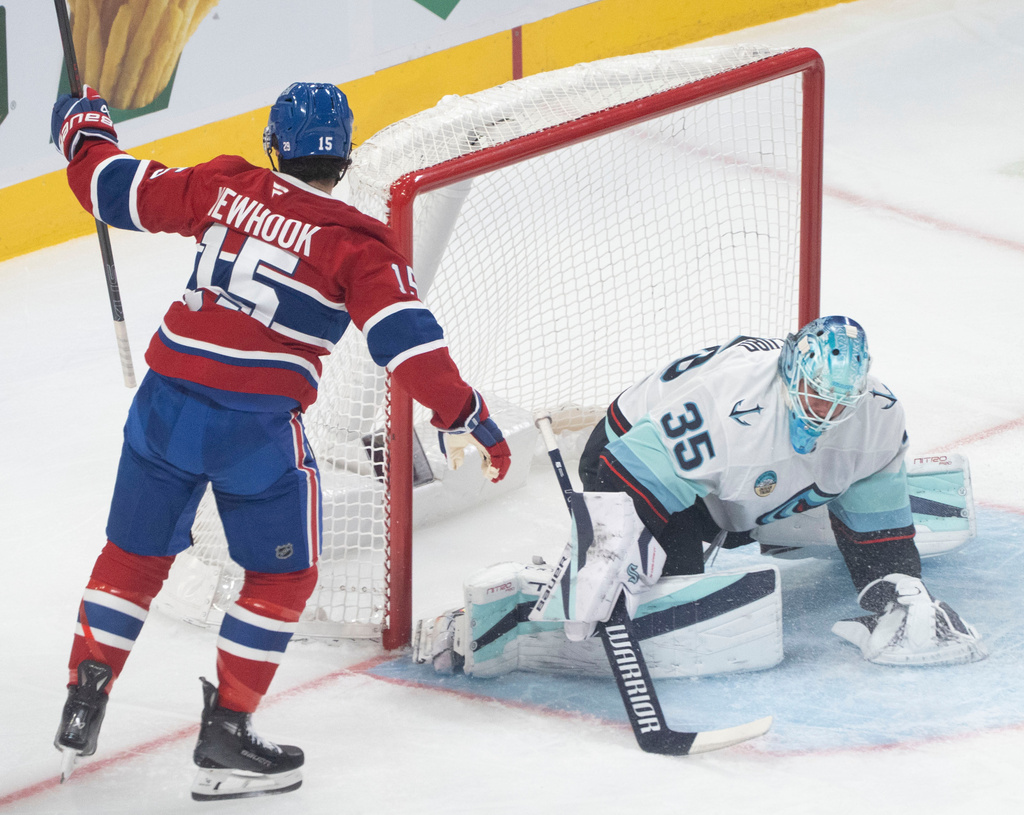 Montreal Canadiens' Alex Newhook (15) celebrates his goal over Seattle Kraken goaltender Joey Daccord (35) during the first period of an NHL hockey game in Montreal on Tuesday, Oct. 14, 2025. (Christinne Muschi/The Canadian Press via AP)