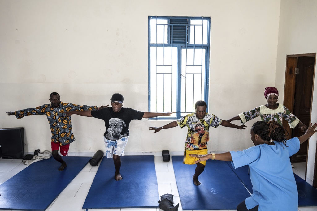 Physiotherapist Gisèle Kantu, bottom right, works with amputees wounded by fighting in the region, at an orthopedic center run by the Catholic church and supported by Red Cross in Goma, eastern Congo, Friday, Aug. 29, 2025. (AP Photo/Moses Sawasawa)
