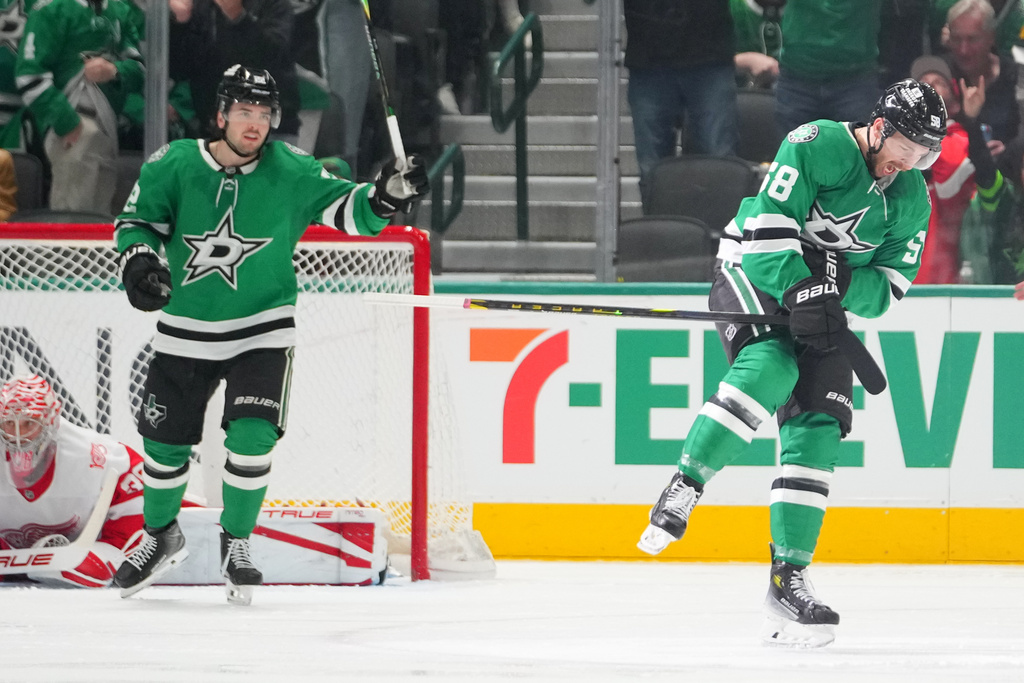 Dallas Stars left wing Michael Bunting, right, reacts after scoring his first career goal with the Stars during the second period of an NHL hockey game against the Detroit Red Wings Saturday, March 14, 2026, in Dallas. (AP Photo/Julio Cortez)
