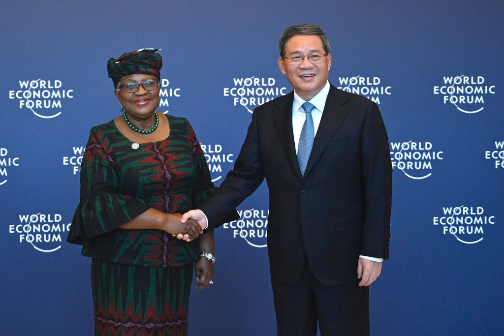 FILE - Chinese Premier Li Qiang, right, shakes hands with Director-General of the World Trade Organization Ngozi Okonjo-Iweala, in Tianjin, ahead of the annual World Economic Forum New Champions meeting Monday, June 26, 2023. (Wang Zhao/Pool Photo via AP, Filer)
