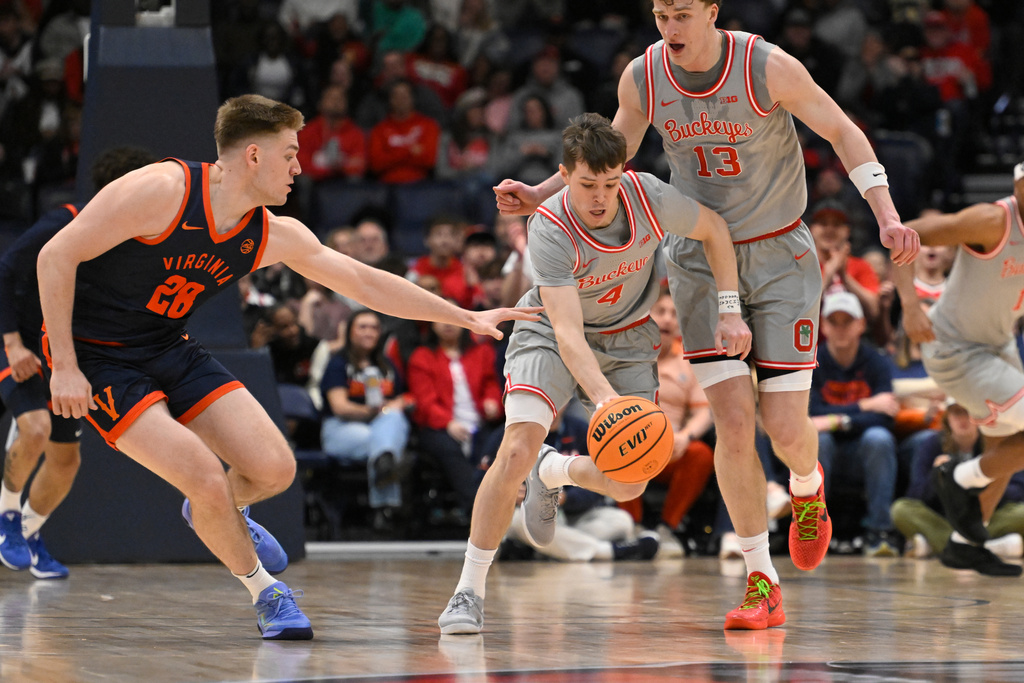 Ohio State guard Gabe Cupps (4) gets a steal as Virginia forward Thijs de Ridder (28) defends during the first half of an NCAA college basketball game Saturday, Feb. 14, 2026, in Nashville, Tenn. (AP Photo/John Amis)