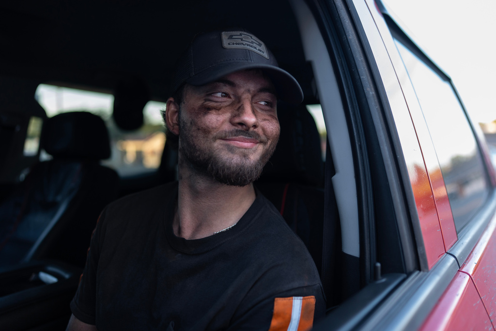 Coal miner Ethan Carper sits in his truck outside a convenience store after work, Sept. 17, 2025, in Oak Hill, W.Va. (AP Photo/Carolyn Kaster)