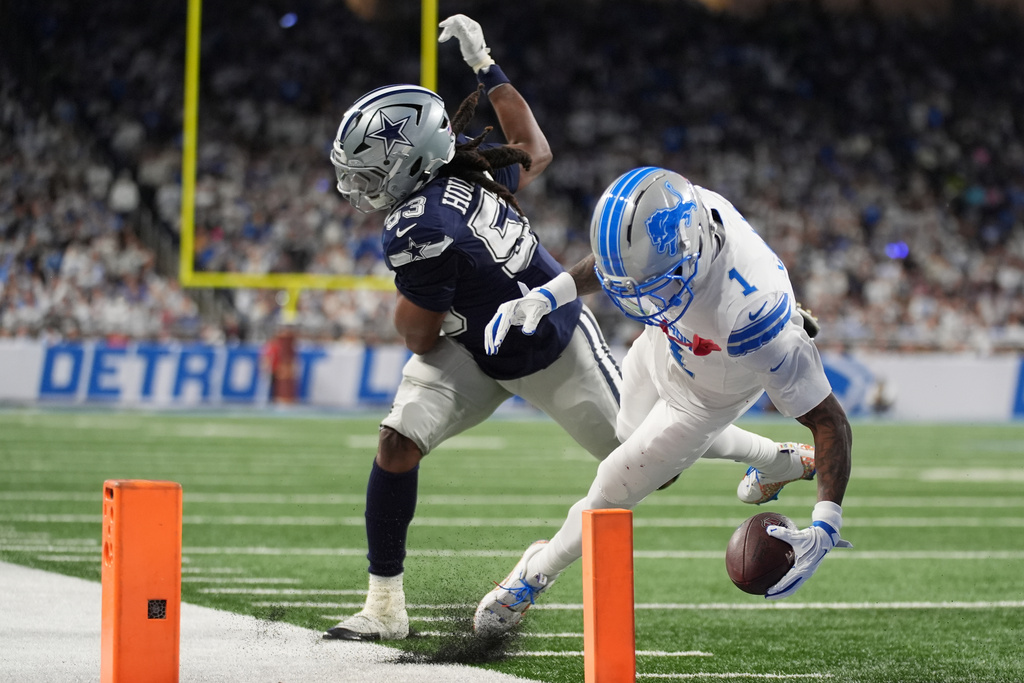 Detroit Lions wide receiver Jameson Williams (1) is stopped short of the goal line by Dallas Cowboys defensive end James Houston (53) during the first half of an NFL football game Thursday, Dec. 4, 2025, in Detroit. (AP Photo/Ryan Sun)