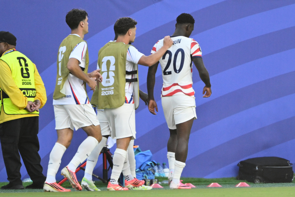 United States' Sebastian Berhalter (14) consoles Folarin Balogun (20) after he received a red card during the World Cup round of 32 soccer match between the United States and Bosnia in Santa Clara, Calif., near San Francisco, Wednesday, July 1, 2026. (AP Photo/Eakin Howard)