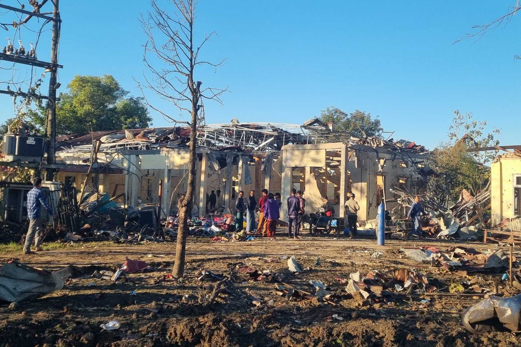 In this photo provided by Wai Hun Aung, people check damaged buildings at the hospital that was allegedly hit by a military air strike in Mrauk-U township in Rakhine state, Myanmar, Thursday, Dec.11, 2025. (Wai Hun Aung via AP)