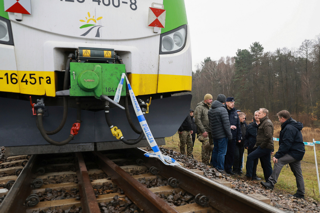 Prime Minister Donald Tusk, second right, visits site of the rail line Mika, that was damaged by sabotage, near Deblin, Poland, Monday, Nov. 17, 2025. (AP Photo/KPRM)