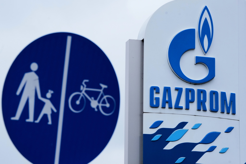 The Gazprom company logo at a petrol station and a traffic sign are seen in Belgrade, Serbia, Sunday, Nov. 23, 2025. (AP Photo/Darko Vojinovic)