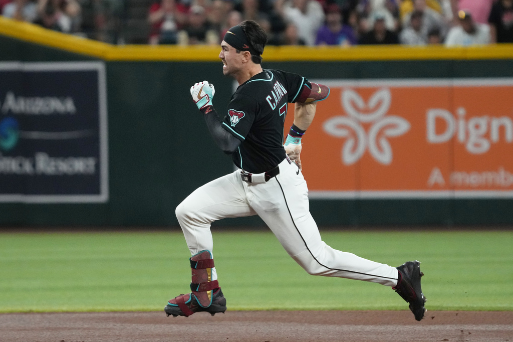 Arizona Diamondbacks' Corbin Carroll runs after hitting a triple against the Colorado Rockies in the first inning of a baseball game, Sunday, May 24, 2026, in Phoenix. (AP Photo/Rick Scuteri)